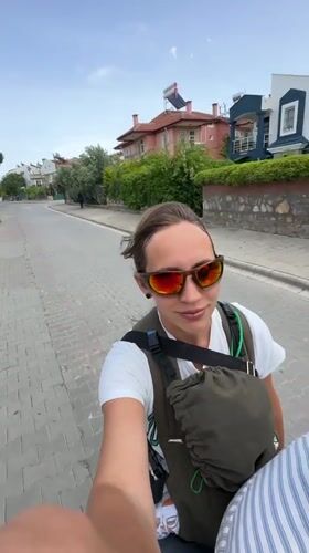 Motorcycle riders travel through residential Fethiye, Turkey streets