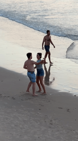 Dancing and a dog on a cloudy Tel Aviv beach