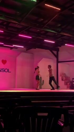 Night stage performance in El Tirano with dancers and festive backdrop