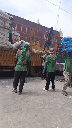 Workers Unload Truck at Nigerian Market in Fagge
