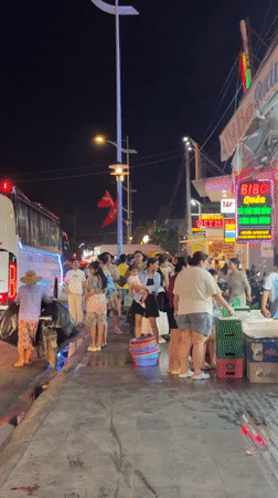 Crowded nighttime street scene captured in Phu Thuy Ward