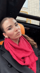 Woman in red scarf spotted in vehicle passenger seat