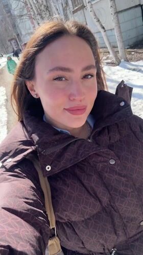 Woman records selfie video while walking in Surgut