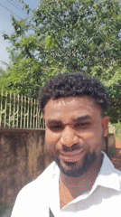 Man makes playful faces at camera in Obosi, Nigeria