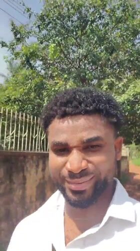 Man makes playful faces at camera in Obosi, Nigeria
