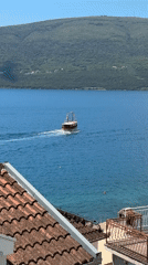 Small boat with flags spotted in waters near Bijela, Montenegro