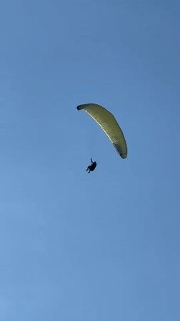 Paragliders soar over Fethiye beaches as tourists enjoy clear skies