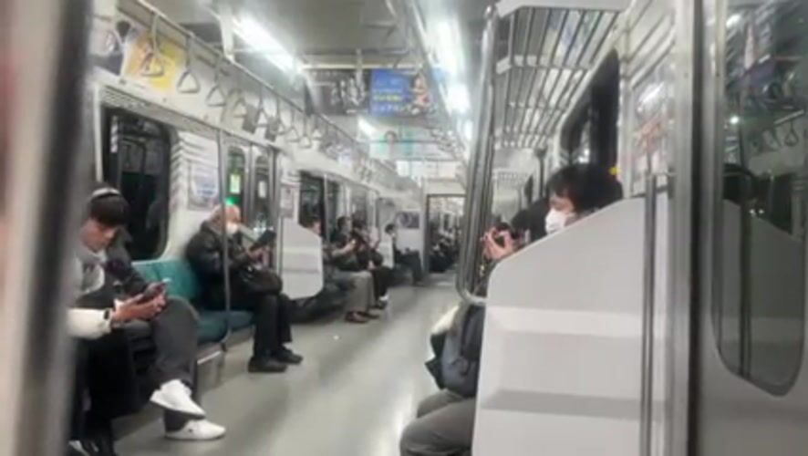 Masked passengers observed on Shinjuku train using mobile devices