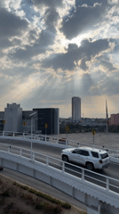 Dramatic sunbeams pierce storm clouds over Puebla cityscape
