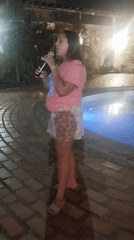 Woman performs poolside concert at late-night Venezuela gathering