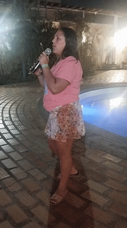 Woman performs poolside concert at late-night Venezuela gathering