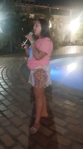 Woman performs poolside concert at late-night Venezuela gathering
