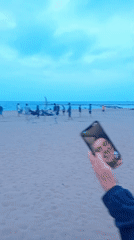 Beachgoers gather on Barcelona sand during evening hours