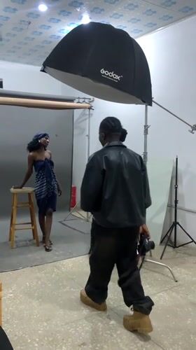 Model poses in blue strapless outfit at Nigeria photography studio