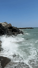Waves breaking against rocky Black Sea shoreline in Pomorie