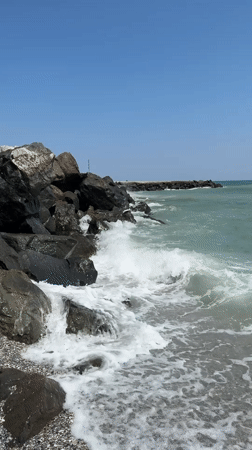 Waves breaking against rocky Black Sea shoreline in Pomorie