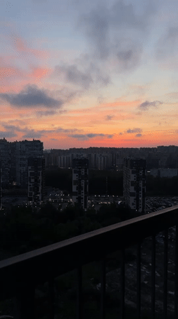 Dusk cityscape captured over Kudrovo, Russia high-rises