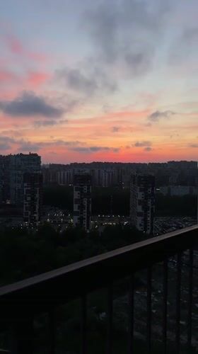 Dusk cityscape captured over Kudrovo, Russia high-rises