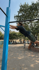 Man performs morning calisthenics workout on Kathmandu playground equipment