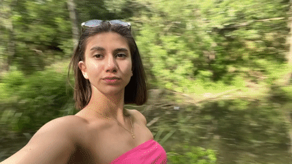 Woman films selfies near wooded pond in Sofia
