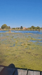 Smoke rises over Sumy as lake and muddy field scenes play out nearby