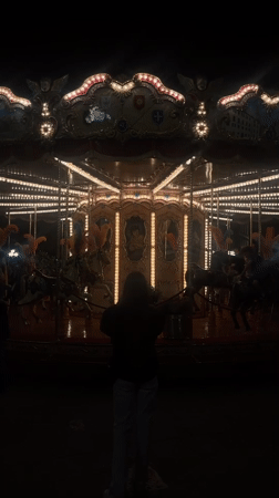 Lone observer watches empty carousel spin in nighttime Florence