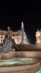 Baroque fountains and basilica lit up in central Rome