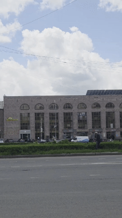 Morning street activity captured near historic stone building in Gyumri