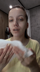 Woman performs evening skincare routine in Russian bathroom