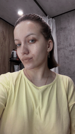 Woman performs evening skincare routine in Russian bathroom