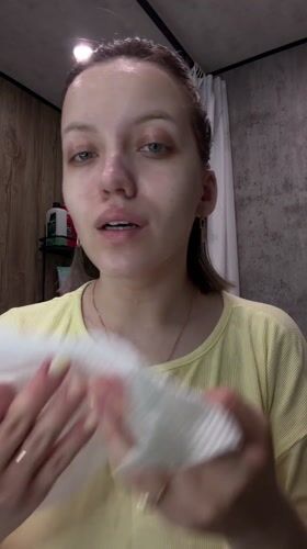 Woman performs evening skincare routine in Russian bathroom
