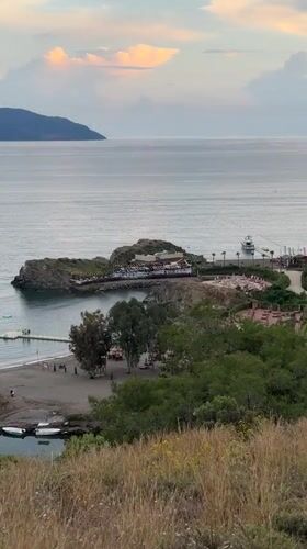 Hiker documents scenic coastal views during Fethiye hillside walk