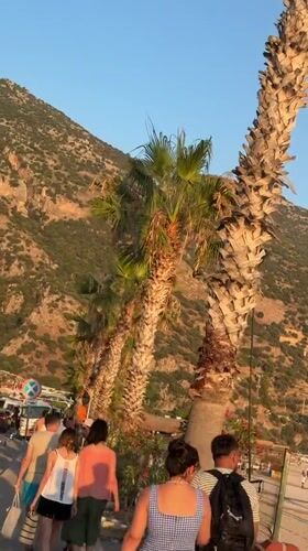 Paragliders land along Fethiye's busy waterfront promenade