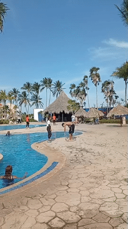 Resort guests enjoy poolside hula hoop activities in Venezuela