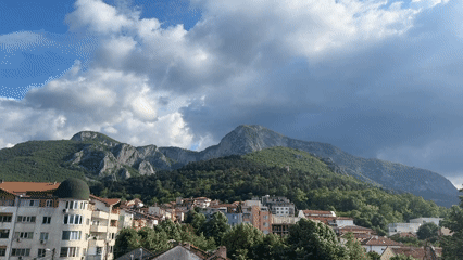 Town of Vratsa captured beneath mountains on cloudy afternoon