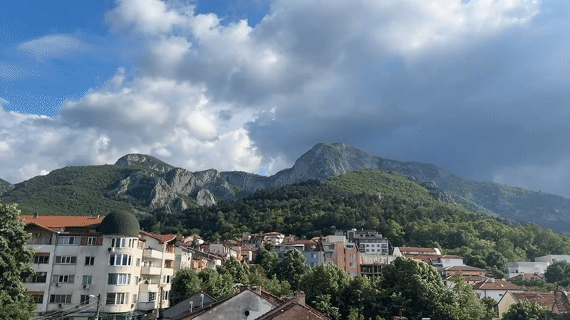 Town of Vratsa captured beneath mountains on cloudy afternoon