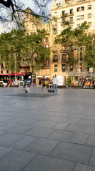 Skateboarders practice tricks in Barcelona city square