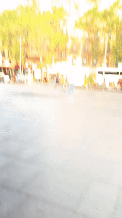 Skateboarders practice tricks in Barcelona city square