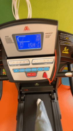 Woman exercises on treadmill at Izhevsk gym early morning