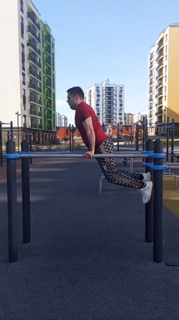 Man exercises on playground equipment in Pervomaysky, Russia