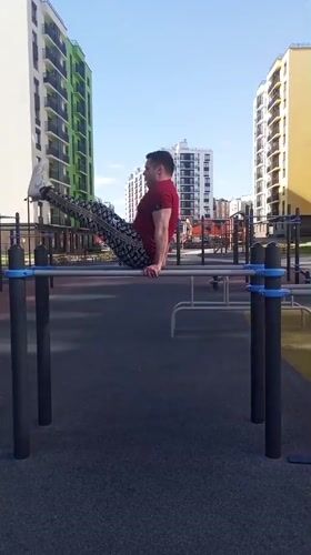 Man exercises on playground equipment in Pervomaysky, Russia