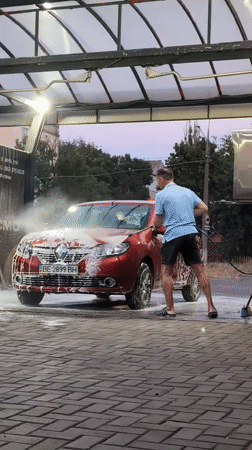 Evening car wash session at an outdoor facility in Mykolaiv