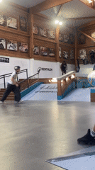 Skateboarder performs rail tricks at French indoor park