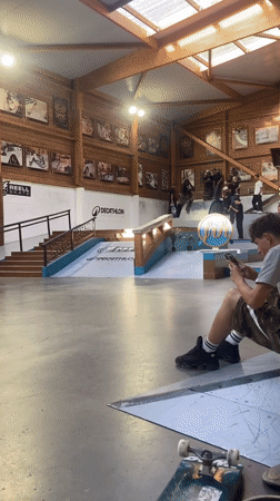 Skateboarder performs rail tricks at French indoor park