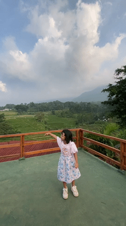 Family visits Indonesian rice terrace viewing platforms, dines outdoors