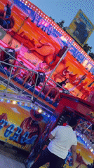 Evening fairground visit in Pamplona features bull-themed rides, food