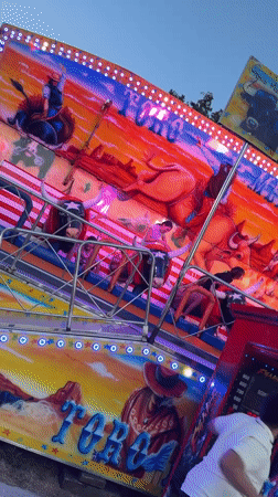 Evening fairground visit in Pamplona features bull-themed rides, food