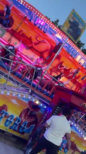 Evening fairground visit in Pamplona features bull-themed rides, food