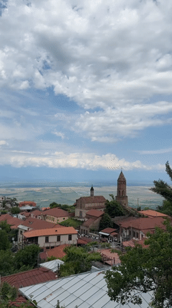 Tourist explores historic Sighnaghi, Georgia capturing scenic town views