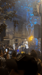 Live music and green paper canopy at Barcelona street festival